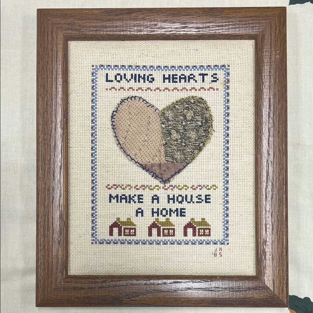 Handmade needlepoint “LOVING HEARTS MAKE A HOUSE A HOME” professionally framed.